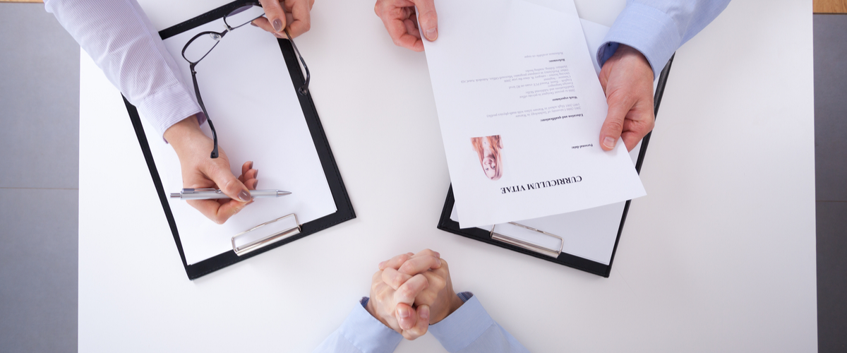 Image of employer holding a CV.