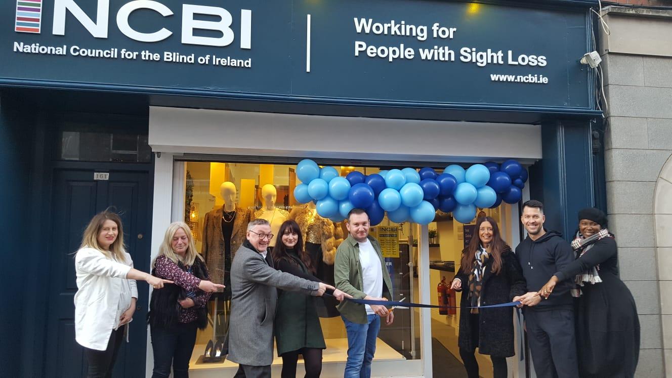 NCBI CEO, Chris White, and NCBI Head of Retail, Beverley Scallan, alongside NCBI volunteers and staff as they cut the ribbon to open the new NCBI shop on Capel Street in Dublin