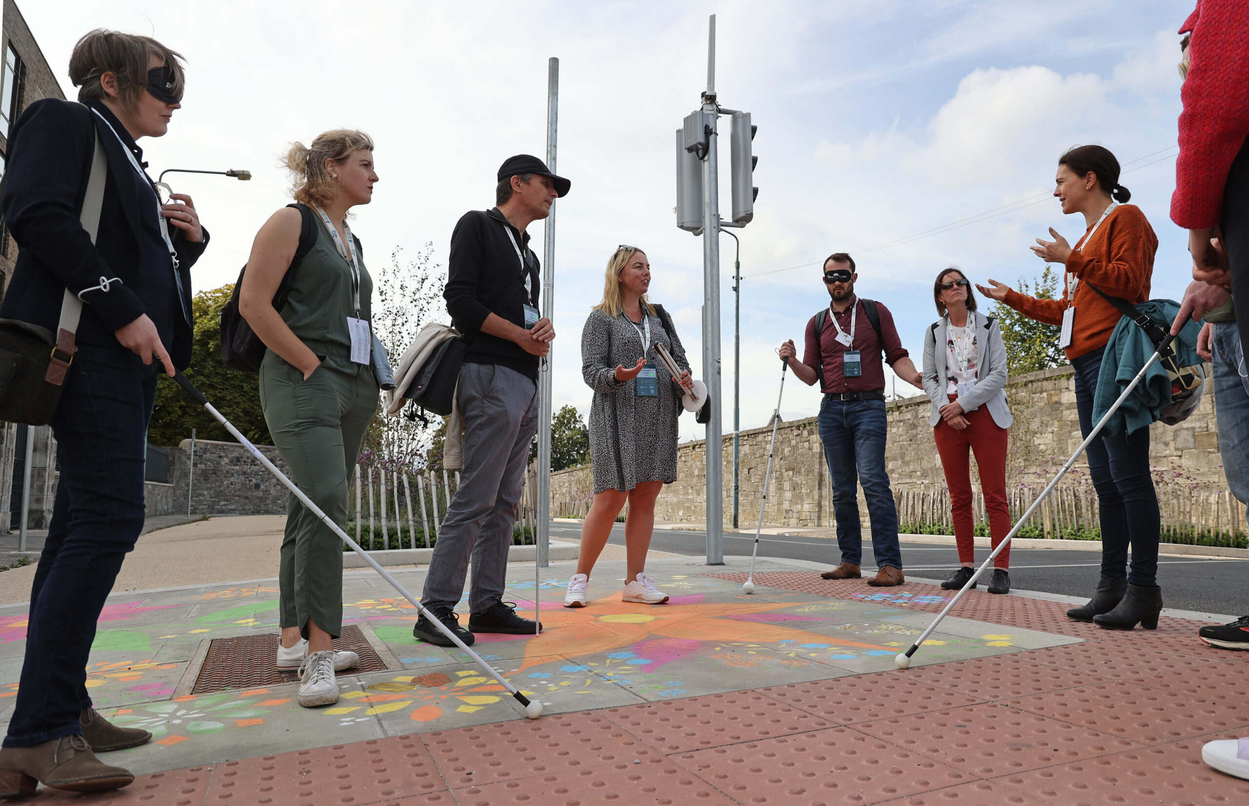 Possibility Labs' Chantelle Smith is standing at a section of tactile paving with a group of people. Some of those people are wearing blindfolds and are using white canes to experience what it is like to navigate the built environment like a person who is blind or vision impaired. Picture credit: Nick Bradshaw.