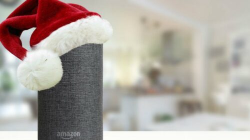 Amazon Echo speaker wearing a red Santa hat