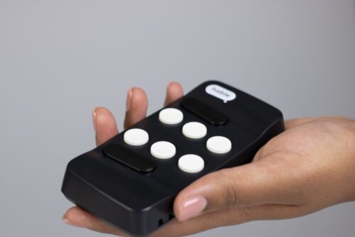 A hand holding the black Hable One with 6 white input keys