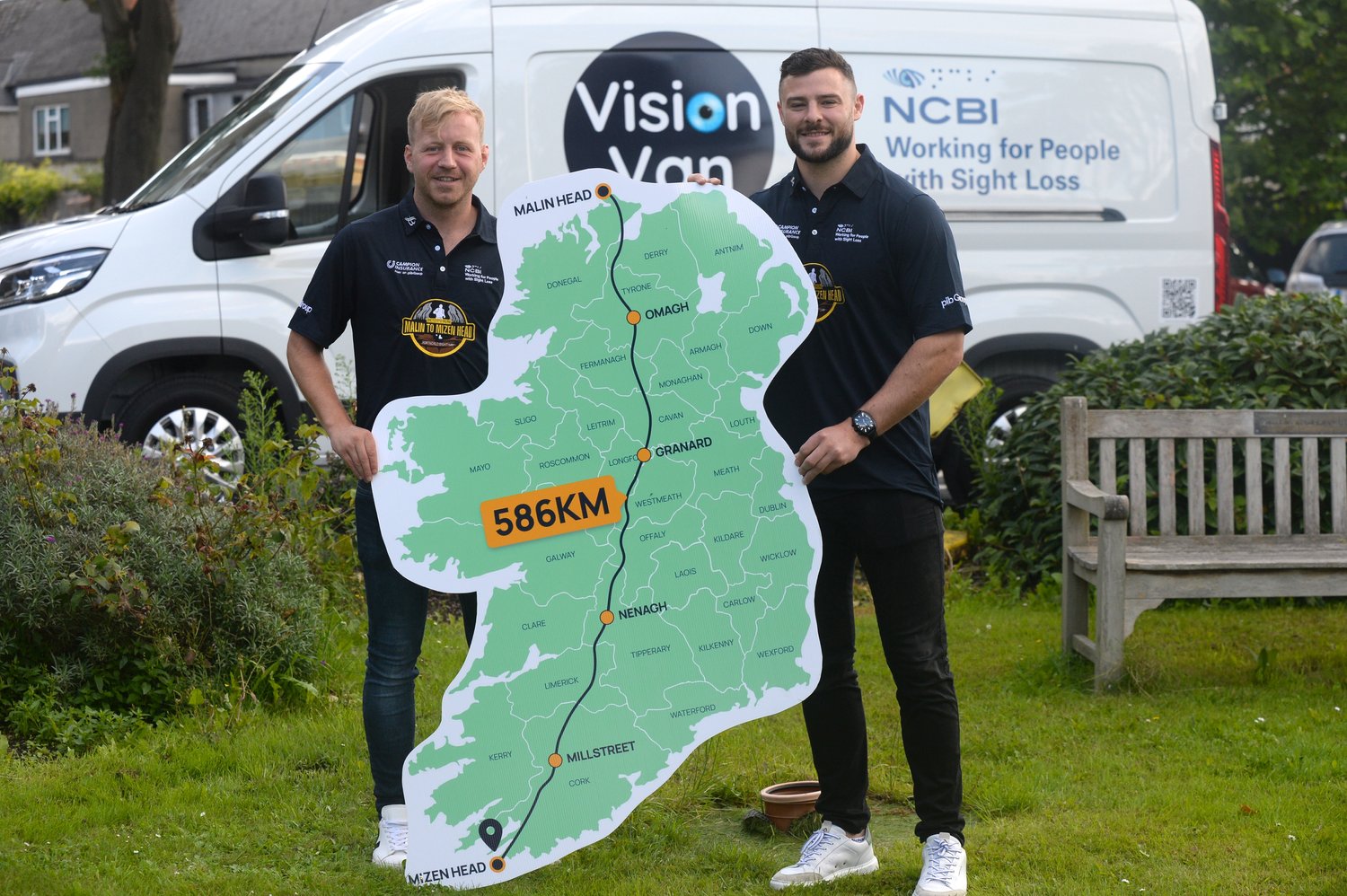 image of Peter Ryan with Robbie Henshaw standing in front of the vision van holding the map